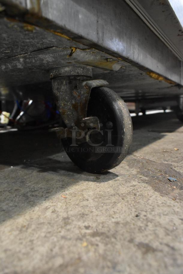 Victory FS-2D-S7-EW-HD cooler caster wheel. Shows wear and rust, indicating heavy use.