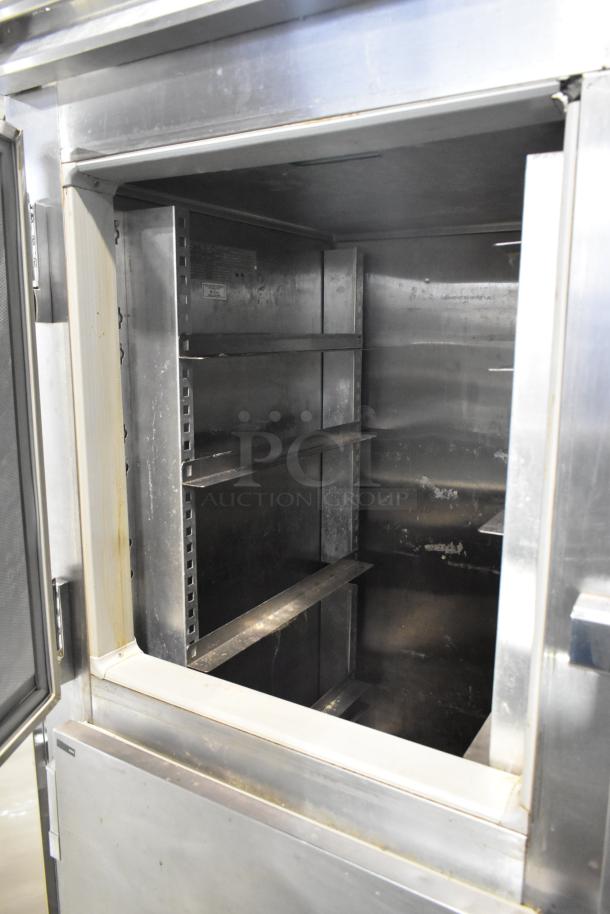 Victory FS-2D-S7-EW-HD stainless steel commercial cooler with 4 half-size doors, interior shelves visible, on casters.