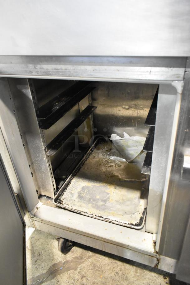 Victory FS-2D-S7-EW-HD reach-in cooler, stainless steel, 4 half doors, commercial casters, used condition, interior needs cleaning.