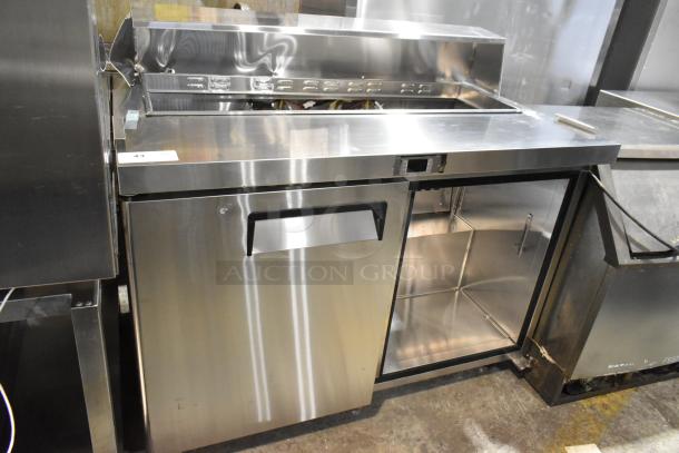 Atosa MSF8302GR stainless steel commercial sandwich salad prep table on casters, missing lid and door, 115V, 1-phase.