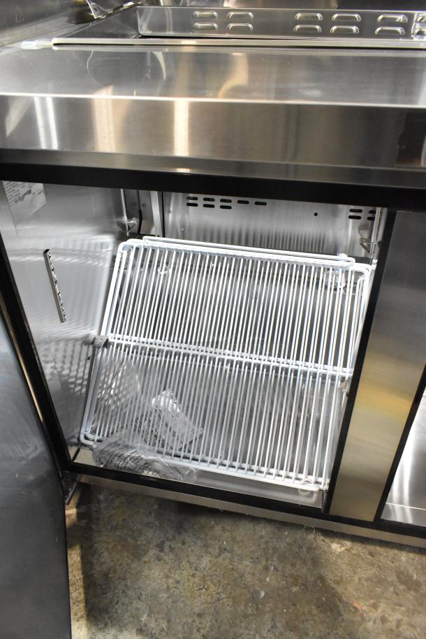 Atosa MSF8302GR stainless steel sandwich prep table on casters, missing lid and door, features visible shelving. 115V, 1 Phase.