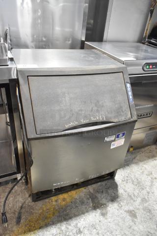 Manitowoc UY0140A-161B stainless steel ice machine, self-contained, 115V, visible wear, labeling indicates functionality.