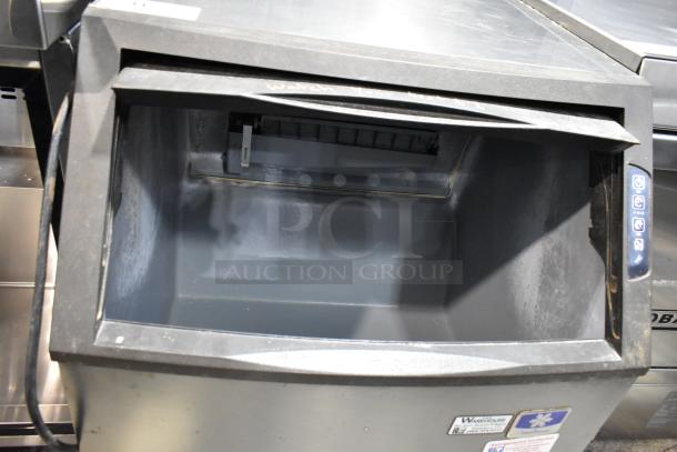 Manitowoc UY0140A-161B stainless steel ice machine, self-contained, 115V, 1 phase, open bin, control panel on side.