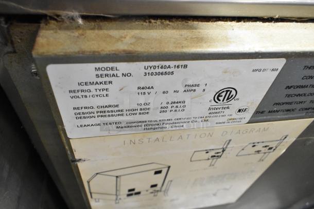 Manitowoc UY0140A-161B stainless steel ice machine label, showing specs: 115V, 1 phase, refrigerant R404A, 10 oz charge.