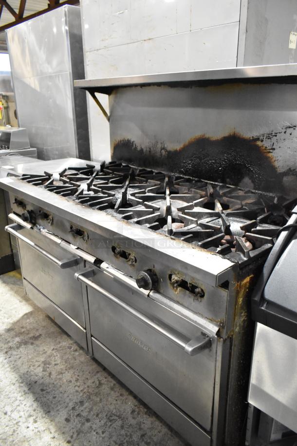 Garland SunFire 10 burner gas range with 2 ovens, overshelf, backsplash, on casters. Used, visible signs of wear.