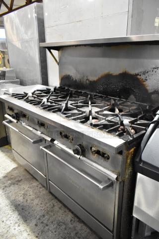 Garland SunFire 10 burner gas range with 2 ovens, overshelf, backsplash, on casters. Used, visible signs of wear.