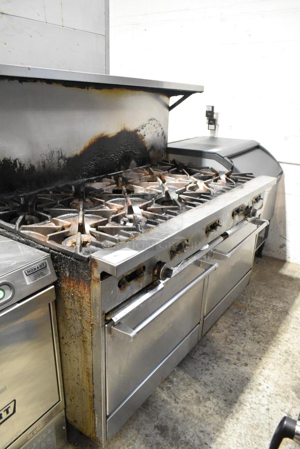 Garland SunFire stainless steel commercial 10 burner gas range with 2 ovens, overshelf, backsplash, and casters. Signs of wear.