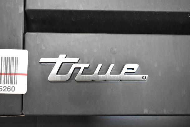True logo on the 2024 STG2RPTVLD-2G-2S-HC commercial cooler door; metal finish, barcode tag visible.
