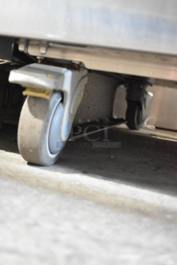 JBT 2ND-GEN-MFJ-HE stainless steel commercial citrus juicer with casters, tested and working, 120V, floor style.