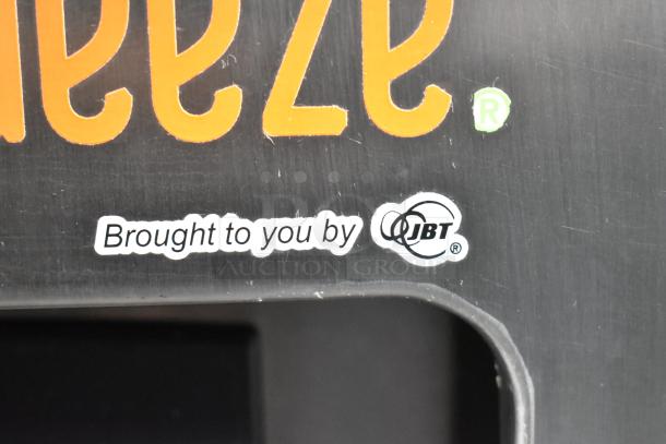 JBT logo on stainless steel JBT 2ND-GEN-MFJ-HE citrus juicer, showing "Brought to you by JBT" label detail.