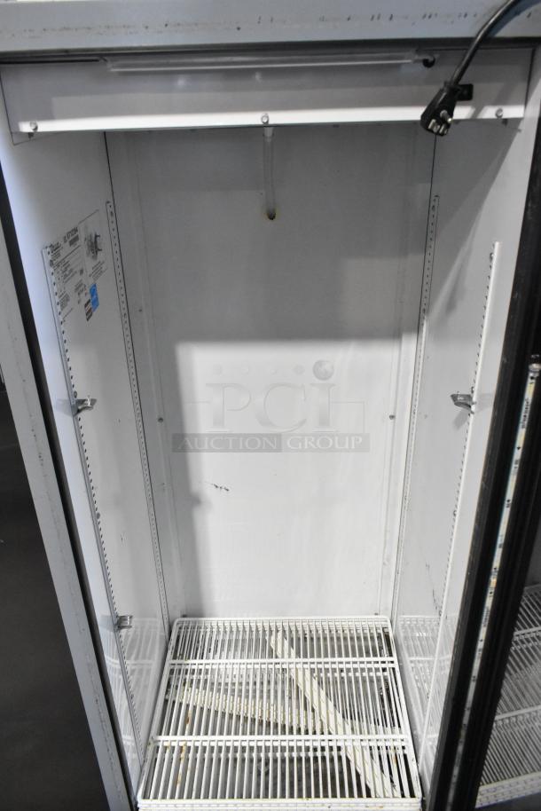 2016 True GDM-12-LD commercial cooler; single glass door, metal body, poly coated racks, 115V, 1 phase, label visible.