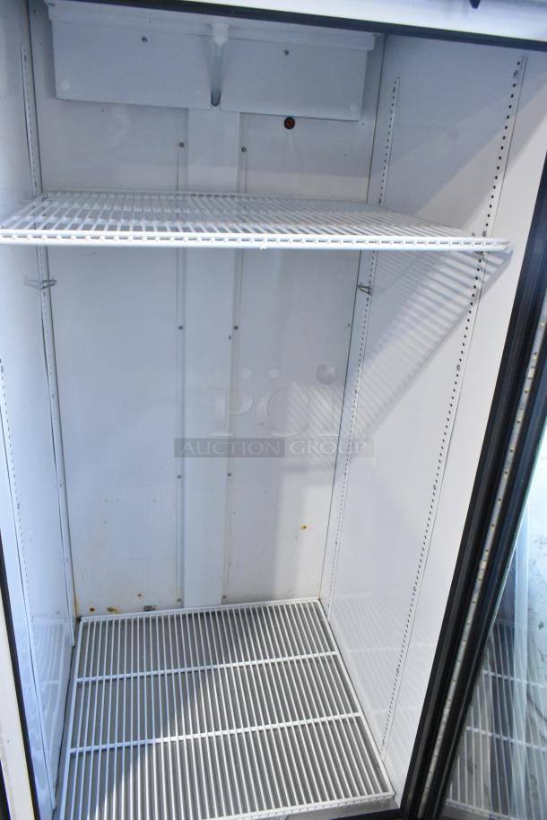 2021 True TSCI-600R-G-PH single door cooler merchandiser, metal, poly-coated racks, 115 volts, clean interior.