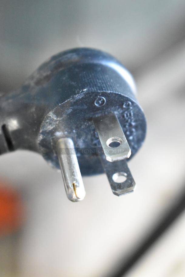 Close-up of a power plug prong for the 2021 True TSCI-600R-G-PH cooler, showing a three-prong design in detail.