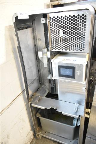 JBT 2ND-GEN-MFJ-HE stainless steel commercial citrus juicer, 120V, 1 phase, on casters, showing internal components.