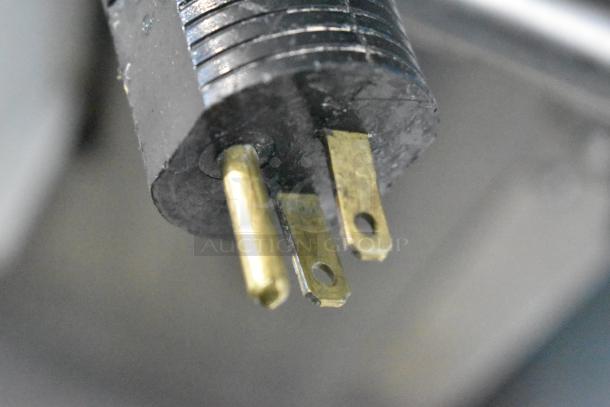 Close-up of a three-prong plug, part of the JBT 2ND-GEN-MFJ-HE Fresh N Squeeze Citrus Juicer, 120V, 1-phase.