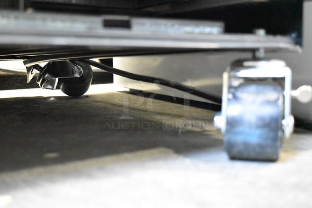 2024 True T-19F-HC stainless steel freezer's commercial caster, poly-coated rack base, showing electrical cord.