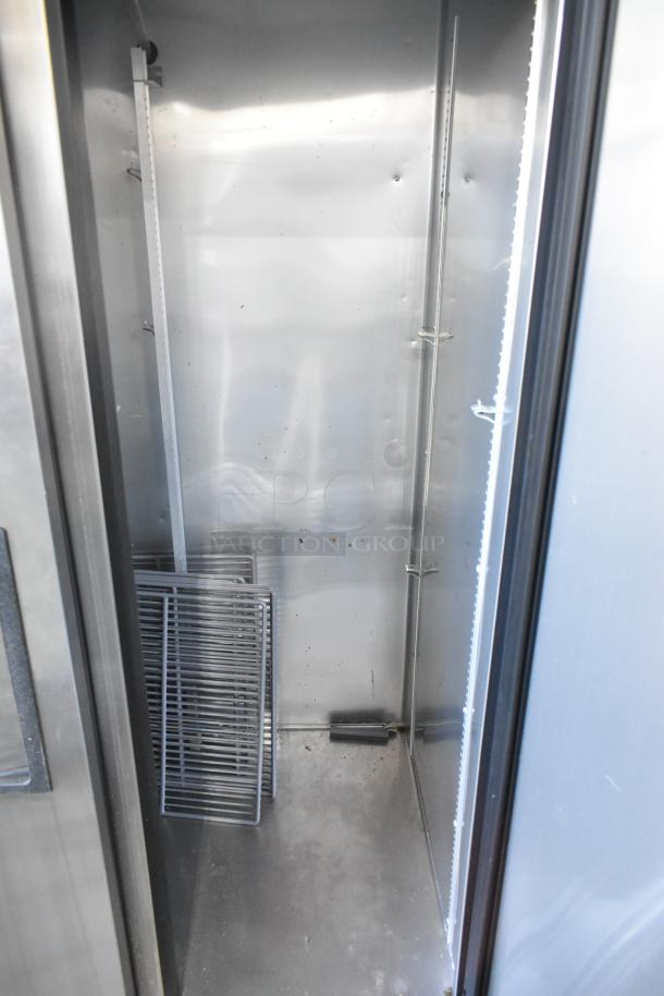 2017 True T-35 stainless steel 2-door commercial cooler interior with poly-coated racks, in used condition, on casters.