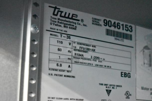 2017 True T-35 stainless steel 2-door cooler, poly coated racks, on casters, 115V, 1 phase; model and serial labels shown.