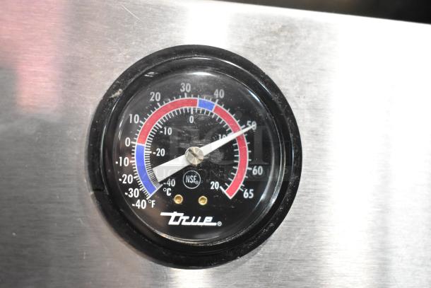 True T-19F freezer temperature gauge on stainless steel, showing temperature range in both Celsius and Fahrenheit.