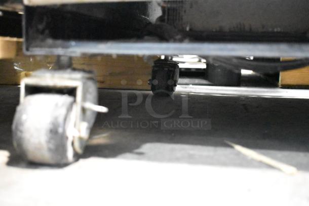 True T-19F stainless steel commercial freezer with poly coated racks, on commercial casters, 115 volts, 1 phase.