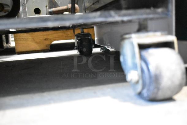 True T-19F commercial freezer on casters, poly-coated racks, 115V, 1-phase, features a stainless steel finish.