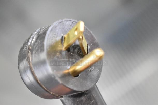 Close-up image of a power plug prong for a 2019 Habco SE18 Commercial Cooler, showing metal pins.