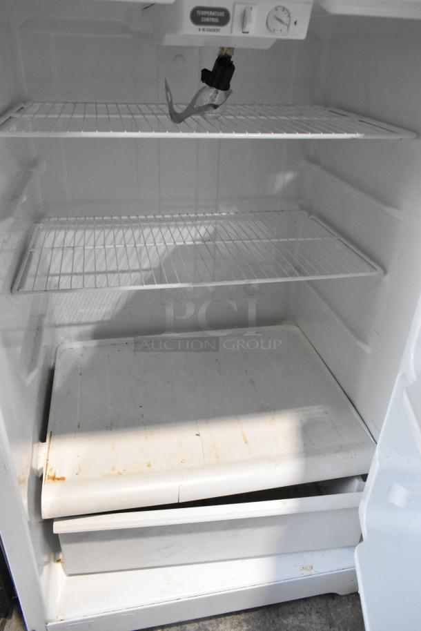 General Electric STS16ABSARWW reach-in cooler with freezer, 115V, single phase. Interior shelves shown, moderate wear.