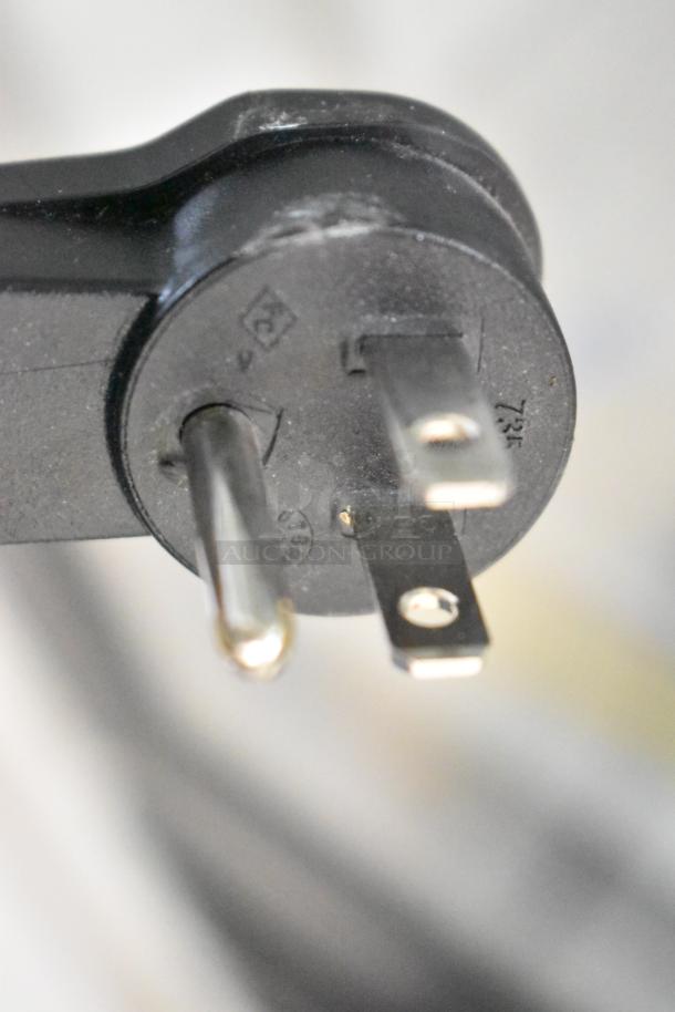 Close-up of a plug for the 2019 Habco SE18 Cooler, 115 volts, showing prongs and markings.