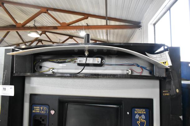 Metal commercial floor-style animal tag engraving machine, featuring touch screen controls and card swipe slot; in used condition.