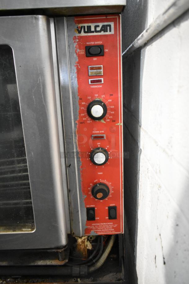 Vulcan stainless steel commercial convection oven, view-through doors, metal racks, thermostatic controls visible. Used condition.