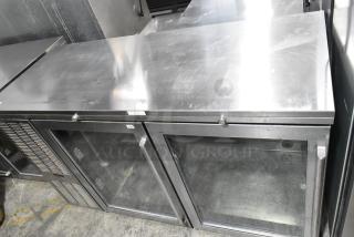 Perlick BS60 metal commercial 2-door back bar cooler merchandiser, model BS60, with glass doors and a steel top, in good condition.