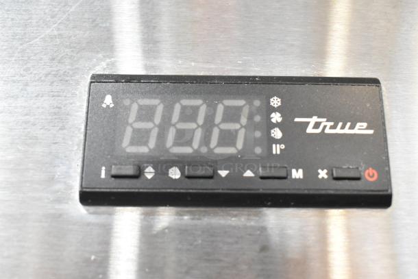 Close-up of control panel for 2019 True TG1R-1S-HC commercial cooler, featuring digital display and control buttons.