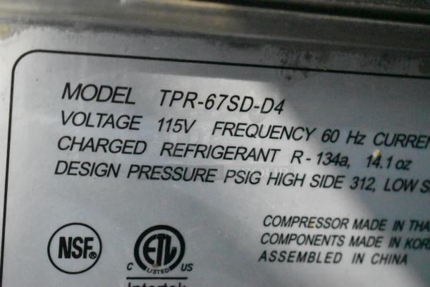 Turbo Air TPR-67SD-D4 pizza prep table label showing model, 115V voltage, and NSF certification.