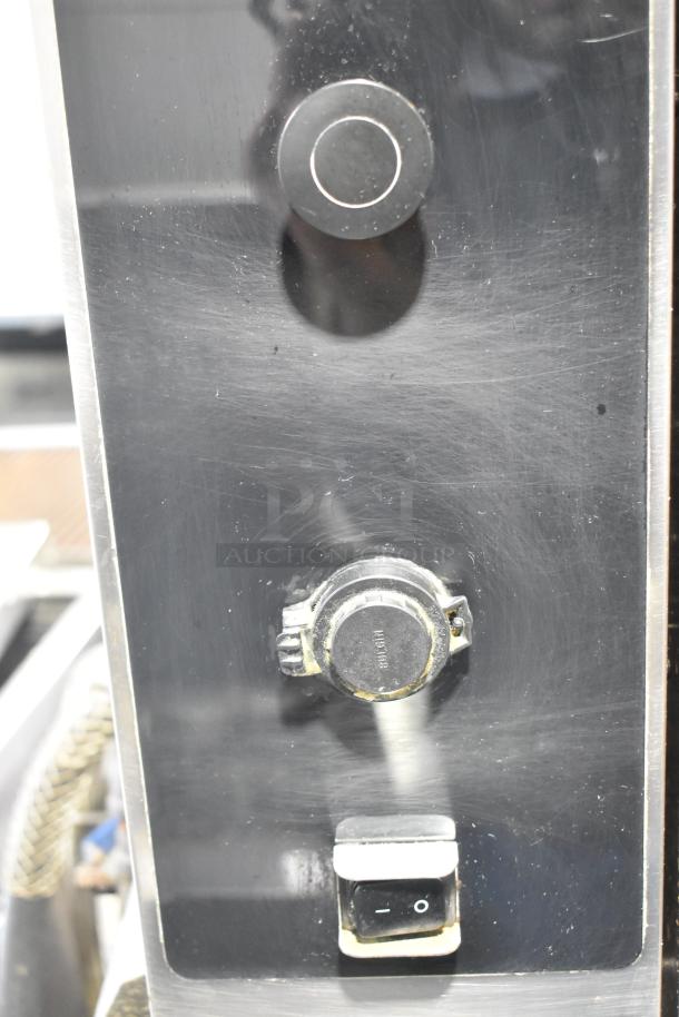 Close-up of Alto Shaam AR-7T rotisserie oven controls on a stainless steel panel, showing knobs and switches.