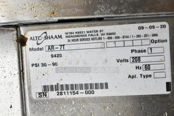 Alto Shaam AR-7T rotisserie oven label, 208 volts, 1 phase, self-cleaning. Model and serial numbers visible.