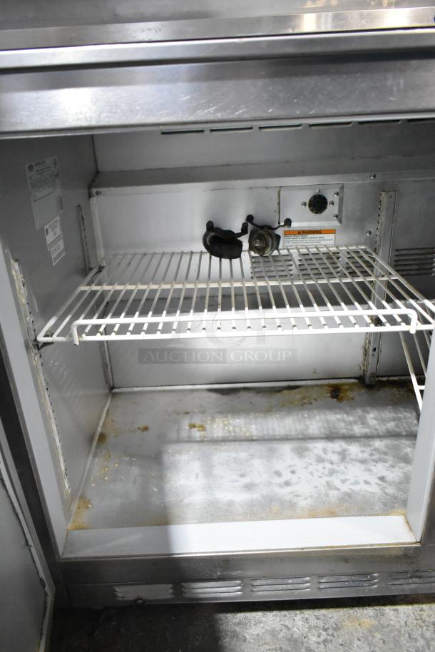 Beverage Air UCR48A stainless steel undercounter cooler, two doors, 115 volts, interior shelving, visible wear.