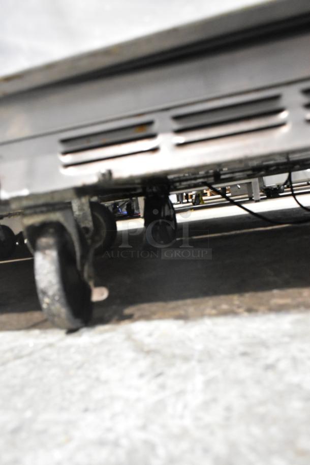 Beverage Air stainless steel prep table on commercial casters. Mega Top design. 115V, 1 phase. Seen from undercarriage.