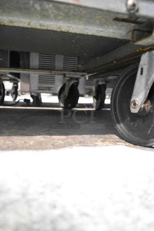 Beverage Air stainless steel sandwich salad prep table, featuring mega top, Bain Marie design, and commercial casters. 115V, 1 phase.