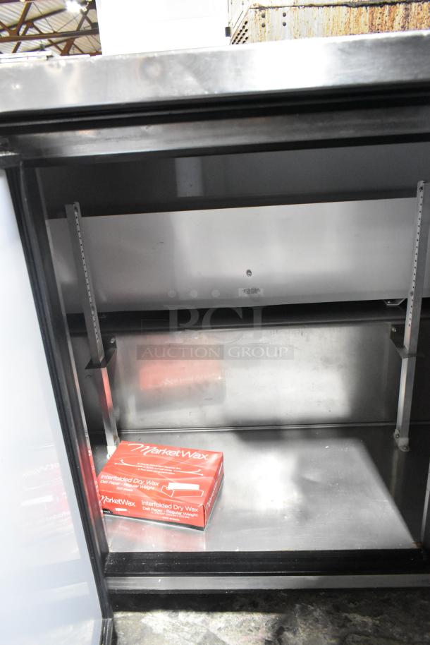 True TWT-72 Stainless Steel 3-Door Work Top Cooler. Commercial-grade, 115 volts, 1 phase, used condition. Interior view.