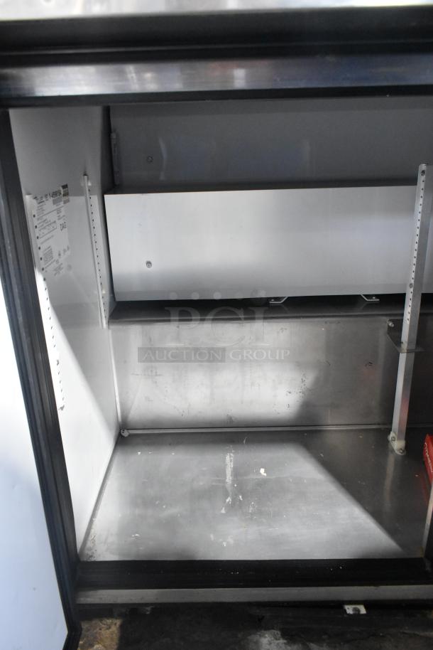True TWT-72 stainless steel commercial 3-door worktop cooler interior. Model and electrical info visible.