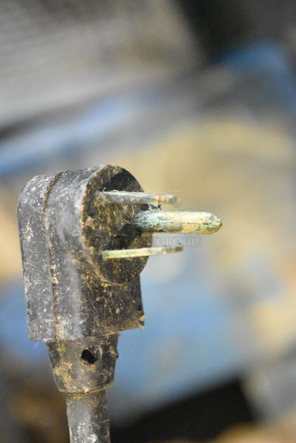 Close-up of a corroded plug from a True TWT-72 cooler, highlighting significant wear and damage.