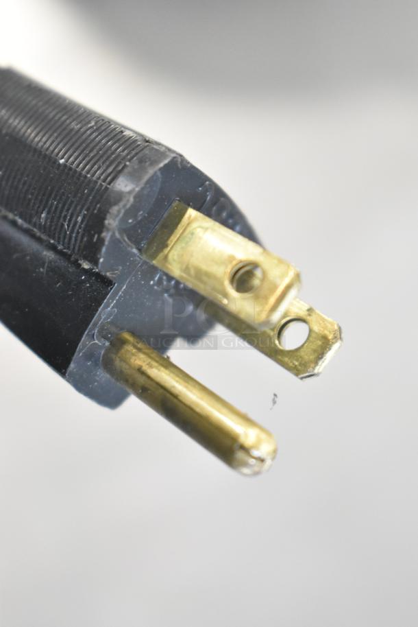 Hobart metal commercial countertop scale plug, 120/208-240 volts, 1 phase, close-up of electrical prongs.