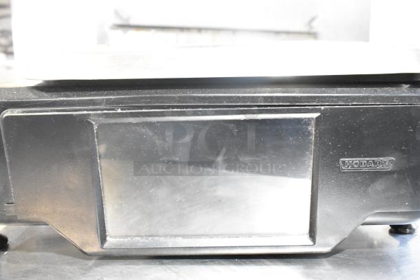 Hobart metal commercial countertop scale, black, with display screen. Uses 120/208-240 volts, 1 phase.