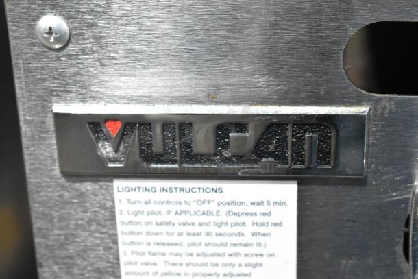 Vulcan VACB36-101 stainless steel charbroiler grill logo and lighting instructions on a commercial equipment stand.