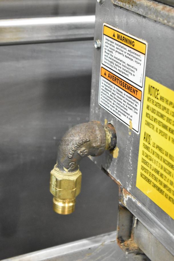 Vulcan VACB36-101 stainless steel commercial gas charbroiler grill's connection feature. Warning labels visible.