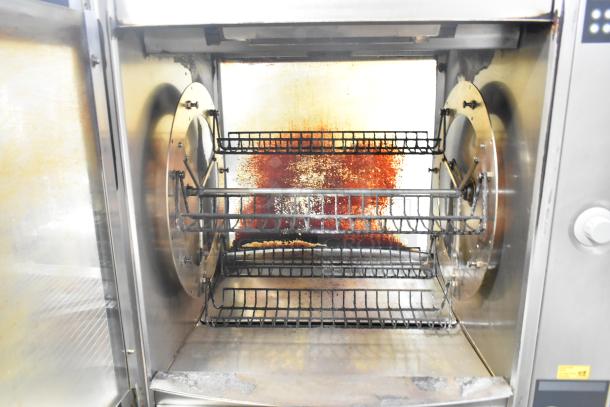 Fri-jado STG7-P stainless steel commercial rotisserie oven with interior racks, electric powered, 208V, 3 phase, on casters.