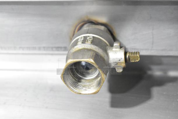 Close-up of a metallic component on a Fri-jado STG7-P stainless steel rotisserie oven, showing threading and possible connection point.