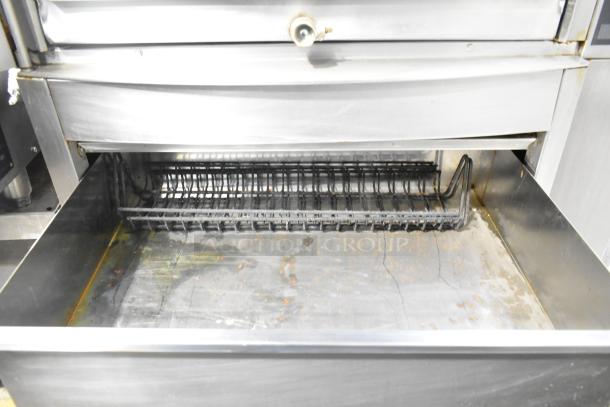 Fri-jado STG7-P rotisserie oven, stainless steel, electric, 208V, 3 phase, on casters, shows signs of use.