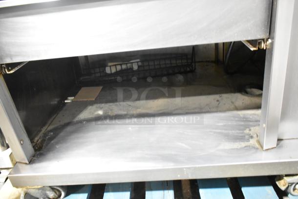 Fri-jado STG7-P stainless steel electric rotisserie oven on casters, 208V, 3 phase, interior view, commercial-grade.