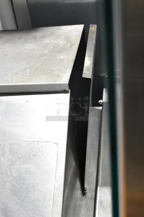 Beverage Air SPE48-18M-HMP stainless steel prep table corner, showing surface wear and sturdy construction details.